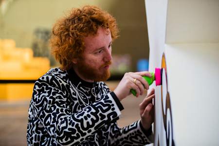 British artist and Red Bull Doodle Art World Final judge Sam Cox, aka Mr Doodle, creates an inspirational work at Amsterdam's STRAAT Museum in April 2023. 