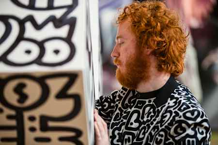 Britain's Sam Cox – known as Mr Doodle – creates an artwork at the STRAAT Museum in Amsterdam, the Netherlands, in April 2023.
