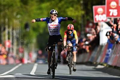 Remco Evenepoel of Red Bull - BORA - hansgrohe celebrates victory at the finish line of the 2026 Amstel Gold Race in Valkenburg, Netherlands, showcasing Red Bull's competitive spirit