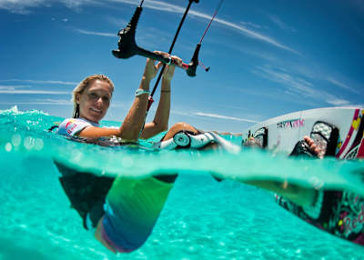 Kitesurfer Susanne Mai pauses in the water for a photo.