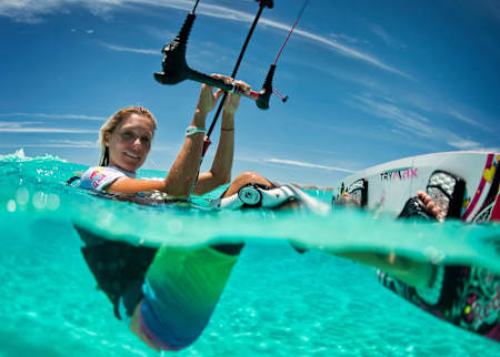 Kitesurfer Susanne Mai pauses in the water for a photo.