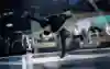 Leony jumping off one leg while rotating upside down.