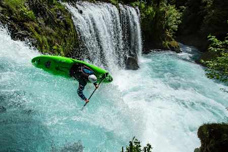 Ben Marr kayaks down a waterfall.