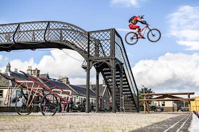 Photo of MTB athlete Danny MacAskill performing a stunt.