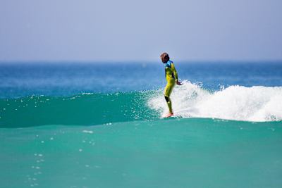 Pro longboarder Adam Griffith surfing at Gwithian Beach, Cornwall