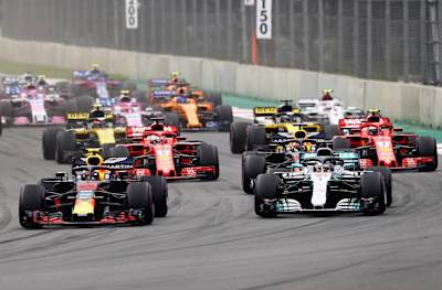 Max Verstappen leads Lewis Hamilton and the rest of the field into turn one at the start during the F1 GP of Mexico at Autodromo Hermanos Rodriguez.