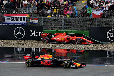 Max Verstappen of Aston Martin Red Bull Racing RB15 passes as Charles Leclerc of Scuderia Ferrari SF90 crashes during the F1 Grand Prix of Germany at Hockenheimring on July 28, 2019.