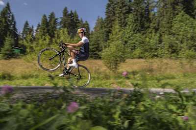 Szymon Godziek performs a wheelie on a road bike in Bukowina Tarzańska, Poland, on August 4, 2017