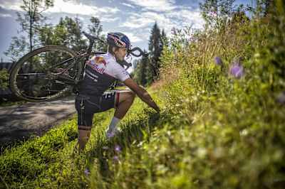 Szymon Godziek carries his bike during his backflip over the Tour de Pologne cycling race attempt on August 4, 2017