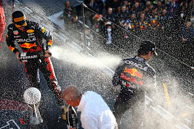 Formel-1-Weltmeister 2022 Max Verstappen und Sergio Pérez bei der Sektdusche auf dem Podest beim Großen Preis von Japan 2022 in Suzuka.