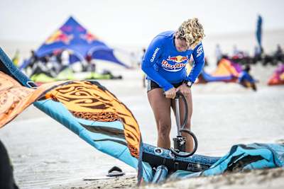 Contestant blows up kite for kitesurfing competition.