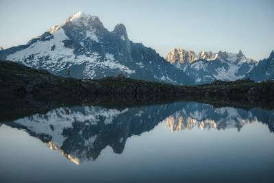Runners training against a mountain backdrop.