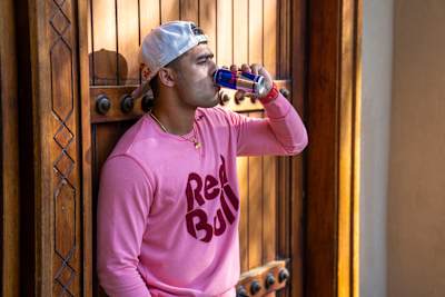 Indian cricket allrounder Riyan Parag drinks a can of Red Bull.