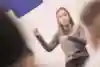 Dassy standing and explaining Pooping to her students.