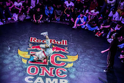 Roxy does a freeze inside of a circle of spectators. San Andrea watching her at the BC One B-Girl World Final.