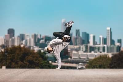 RoxRite balancing on one hand in front of the San Francisco skyline.
