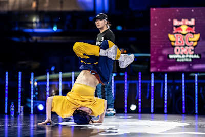 Kami of France competes against Ayane (background) of Japan during the Red Bull BC One World Final at Hangar-7, in Salzburg, Austria on November 28, 2020.