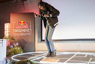 Nandhika Venkateswaran jumps on a panel to demonstrate the EnergyBrid system at the Red Bull Basement University World Finals in Toronto.