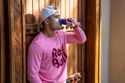 Indian cricket allrounder Riyan Parag drinks a can of Red Bull.