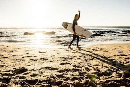 Jordy Smith walks along the beach at Jeffreys Bay in South Africa.