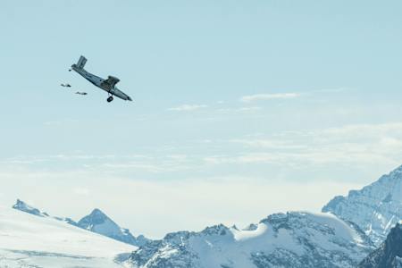 The soul flyers succeed in flying into the open door of an aircraft in mid-air, after BASE jumping off the summit of Jungfrau (4,158m) in the Alps, Lauterbach, Switzerland.
