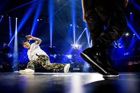 B-Boy Focus dancing on the floor at the big stage of Red Bull BC One.