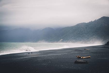 Dyland Bowman and Rickey Gates run across the Black Sands Beach in Shelter Cove, California on March 8, 2018.