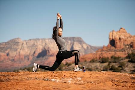 Kate Courtney practices Surya Namaskar with a variation of Ashwa Sanchalanasana.
