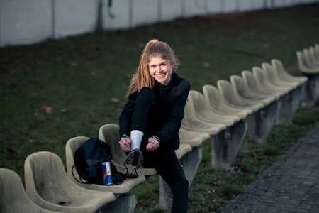 Running ace Konstanze Klosterhalfen laces up her running shoes before running training.