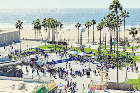 Participants in the Red Bull 3X basketball tournament play on a basketball court in Venice Beach, California, to advance to the next round.