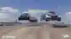 A screenshot from the new Red GRC racing discipline iRacing showing cars flying over a jump.