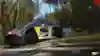 Screenshot of a Red Bull vehicle driving through palm trees in DIRT 5.