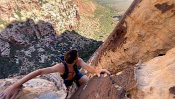 Alex Honnold looks down from where he's come while climbing Red Rock Canyon, Nevada in a shot from Reel Rock S9 E10