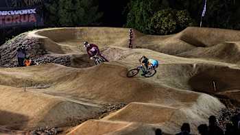 Ryan Gilchrist and a fellow competitor perform at the Pump Track Challenge at Crankworx in Rotorua, New Zealand, on March 23, 2024