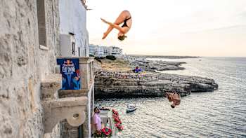 Morgane Herculano, Yolotl Martinez and Sergio Guzman execute a thrilling mass dive during Red Bull Cliff Diving World Series training at Polignano a Mare, Italy on June 27, 2025
