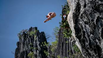 Molly Carlson of Canada performs a daring cliff dive from 21.5m at Lagen Island on the first day of the Red Bull Cliff Diving World Series 2025 in El Nido, Philippines
