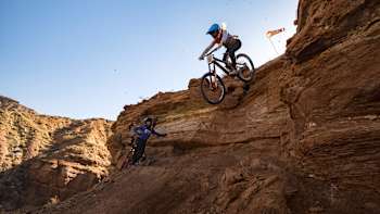In 2024, Casey Brown fearlessly descends a steep cliff on her mountain bike at Red Bull Rampage in St. George, Utah, showcasing unmatched skill and Red Bull's adventurous spirit