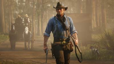 Arthur Morgan walks along a road in Red Dead Redemption 2, by Rockstar Games.