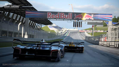 A screenshot of two Red Bull X2014s racing through the Red Bull Ring starting line in the video game Gran Turismo 7.
