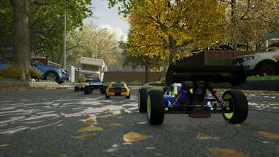 Screenshot from Volt Recharge shows several RC cars racing on a road in autumn. 