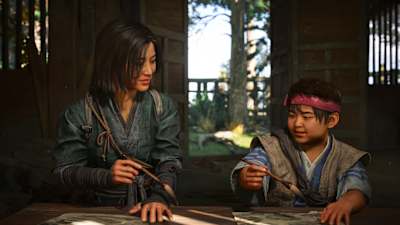 Screenshot from Assassin's Creed Shadows shows Naoe painting with a child.