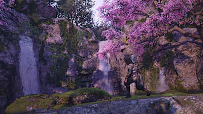 Screenshot from Assassin's Creed Shadows shows Naoe at a pond with blossoming cherry trees.
