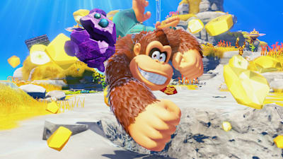 Screenshot aus Donkey Kong Bananza zeigt DK und den sprechenden Stein.