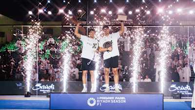 Agustin Tapia and Arturo Coello celebrate their victory at Premier Padel Riyadh Season P1 in Saudi Arabia, February 2026, raising their winner trophies amid a dazzling ceremony.