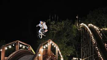 Kriss Kyle rides his BMX on the wooden rollercoaster at the Bakken amusement park near Copenhagen for Everyday Wonders.
