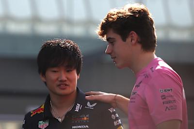 Yuki Tsunoda y Franco Colapinto conversan en el Desfile de Pilotos del Gran Premio de Abu Dhabi, 2025.