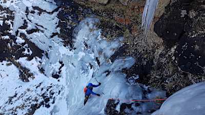 Ice climber uses ice axes to scale Drakensberg climb in South Africa.