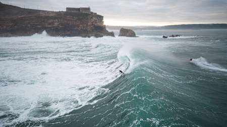 Kai Lenny op Nazaré, met de vuurtoren op de achtergrond