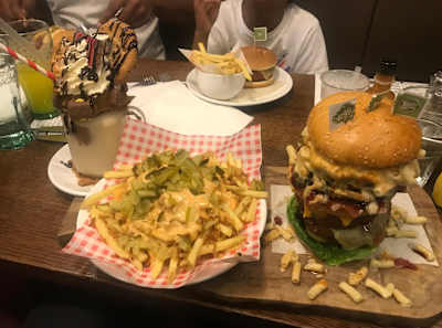 One of Julian's eating challenges – a whopping burger, fries and cookies
