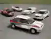 A Lancia Fulvia, an 037, a Stratos and two Deltas are displayed on the tarmac. 